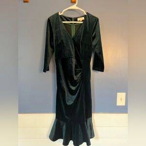 Dark green velvet, tea length dress with ruffled skirt hem